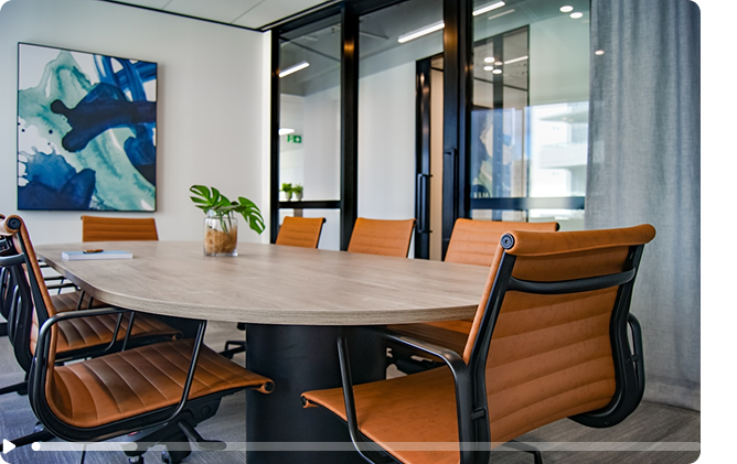 Modern conference room with oval table and leather chairs